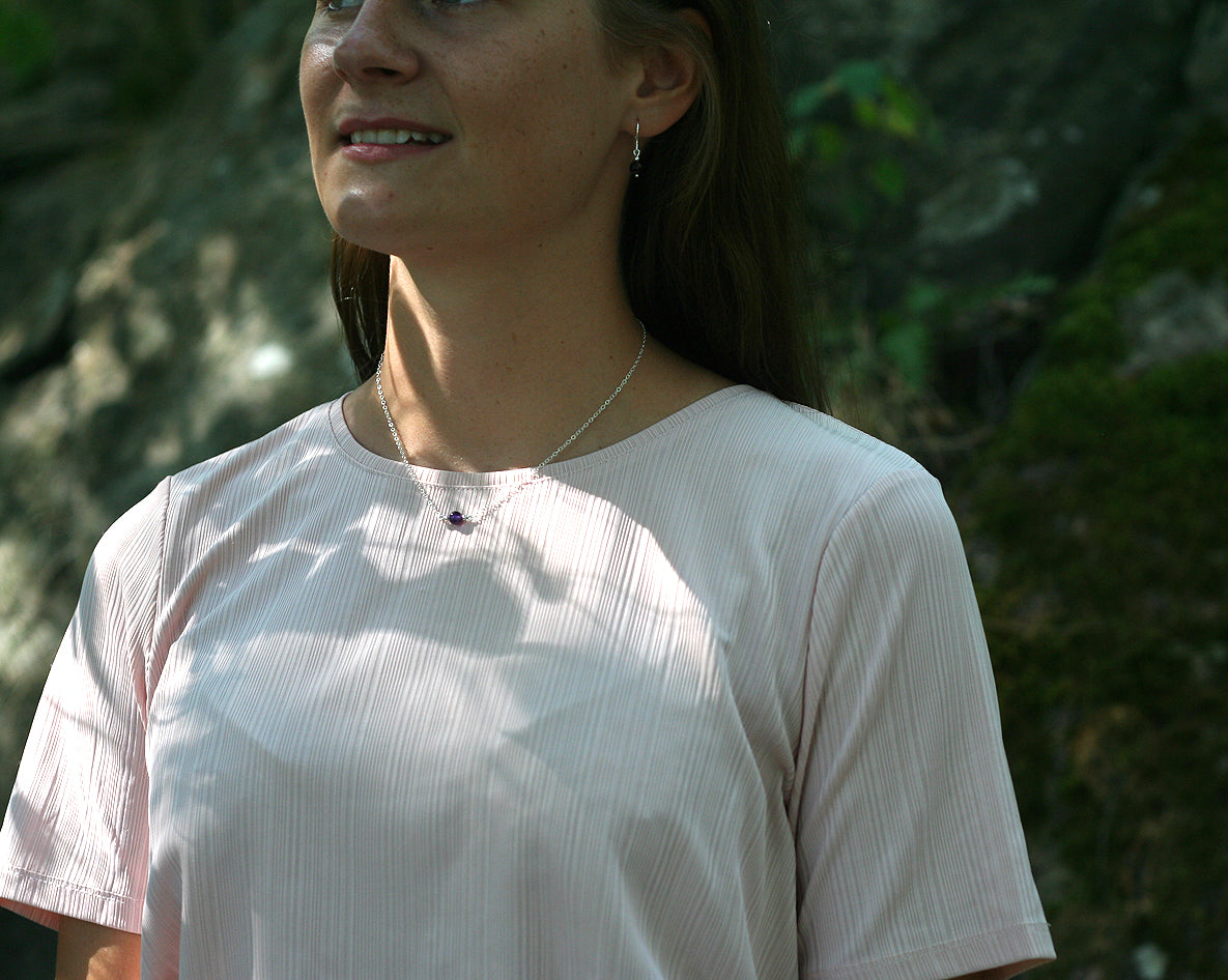Woman wearing  amethyst bead minimalist necklace .