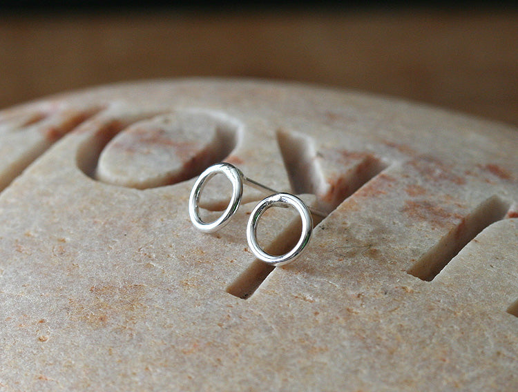 Tiny circle stud earrings in sustainable sterling silver. Handmade in New Jersey, US.