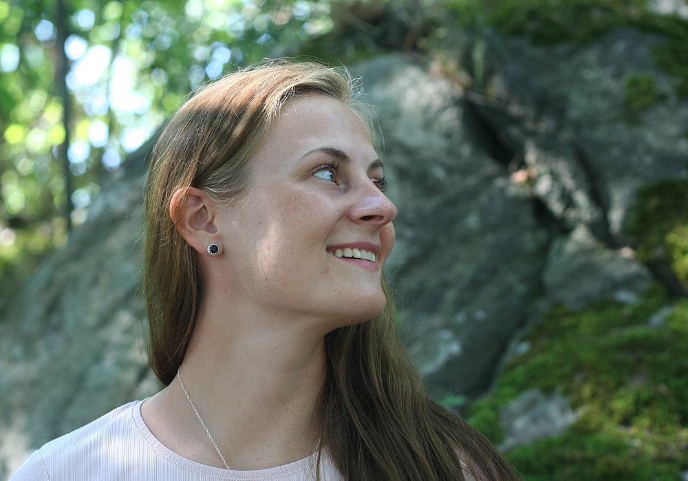 Woman wearing crown earrings with ethical stones and sterling silver. Handmade in New Jersey, US.