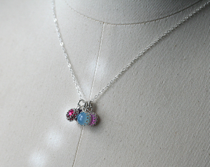 Cluster of birthstone crown pendants. Sustainable sterling silver. Handmade in New Jersey, US.