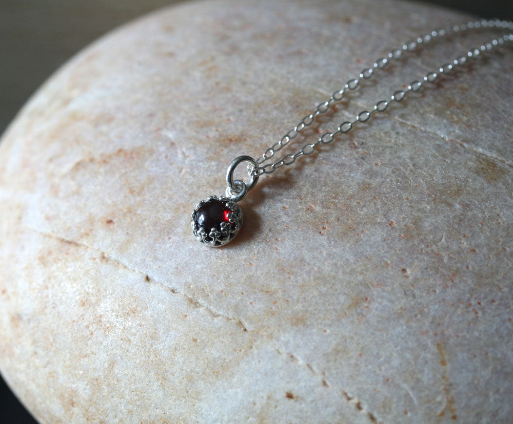 Small garnet princess crown pendant necklace in sustainable sterling silver. Handmade in New Jersey, US.
