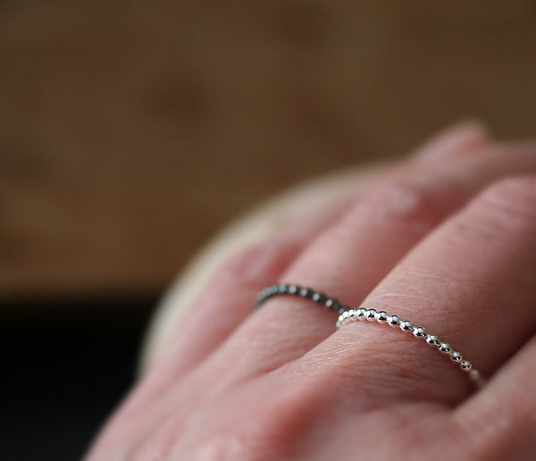 Beaded stacking rings on hand in ethical sterling Silver
