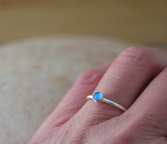 Ethical blue spinel stacking ring in sterling silver on hand. Handmade in the US.