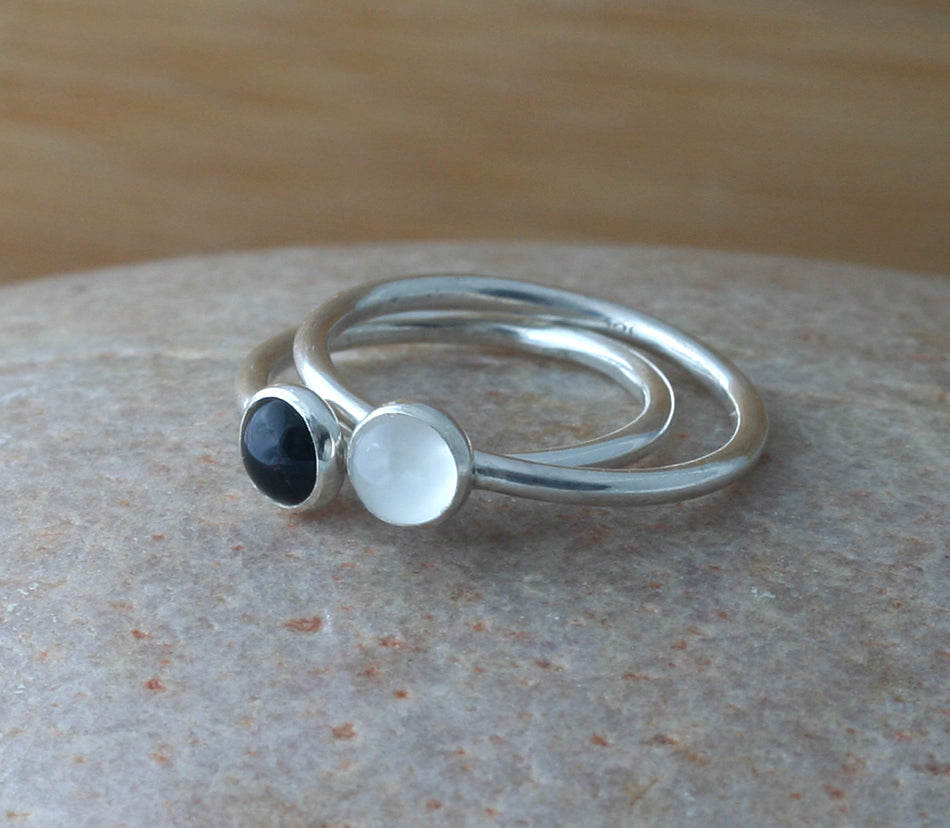 Small black onyx and moonstone stacking rings in all sizes. Sterling silver. Minimalist design. Handmade in the US with sustainable silver.