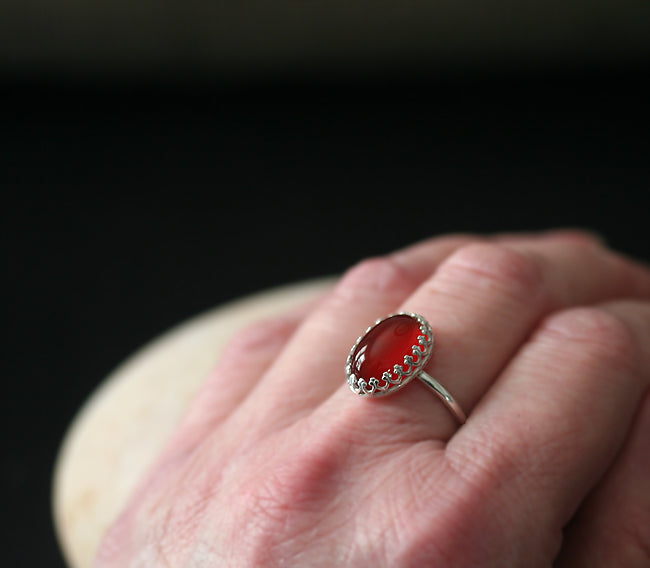 Ethical oval carnelian princess crown stacking ring in all sizes. Sterling silver. On finger. Handmade in the US with sustainable silver.