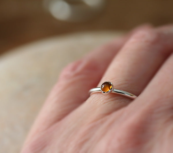 Citrine stacking ring on finger. Sterling silver. Handmade in the US with sustainable silver.
