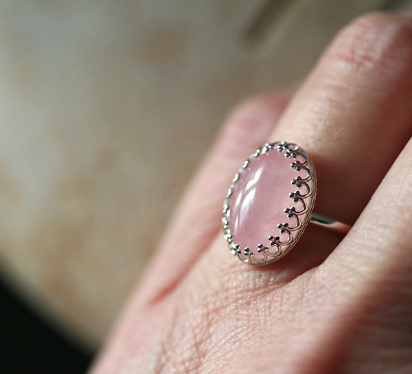 Rose quartz princess crown ring in sustainable sterling silver. On finger. Handmade in New Jersey, US.