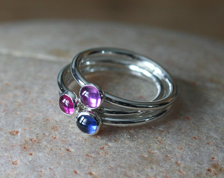 Ruby, blue and pink sapphire birthstone stacking rings in sustainable sterling silver. Handmade in New Jersey, US.