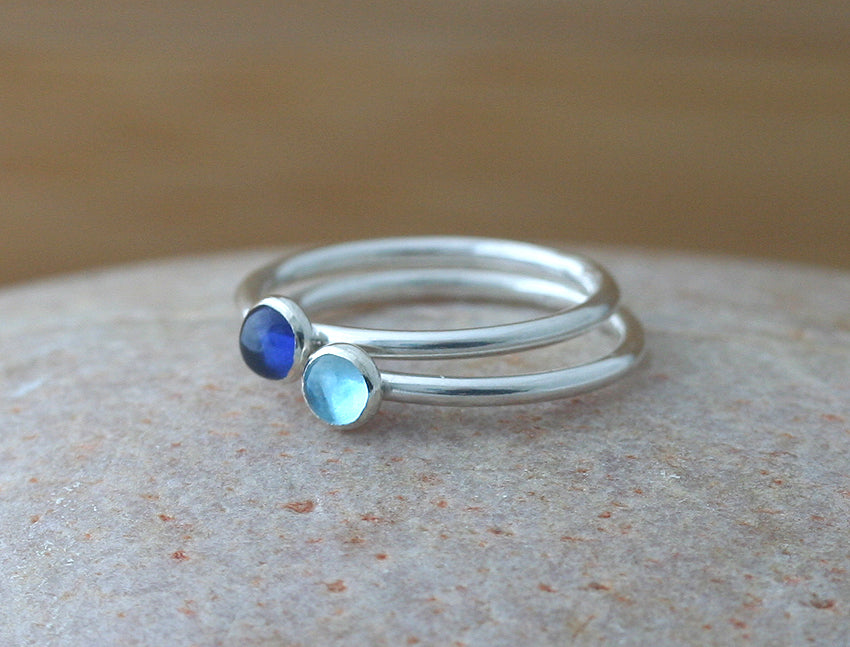 Ethical blue sapphire and aquamarine stacking rings in sterling silver. Handmade in the US.