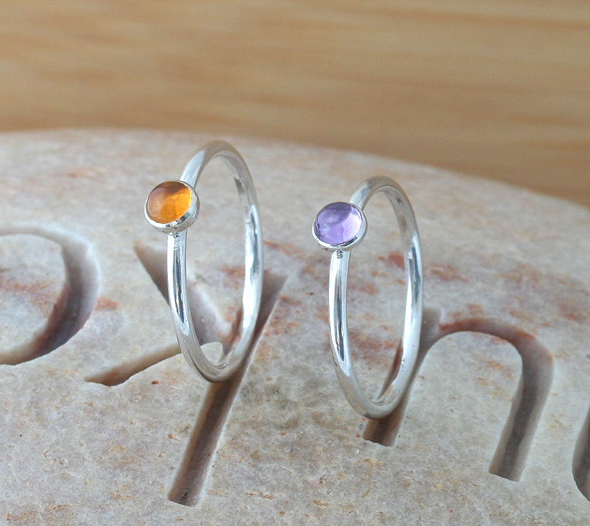 Citrine and alexandrite stacking rings on finger. Sterling silver. Handmade in the US with sustainable silver.