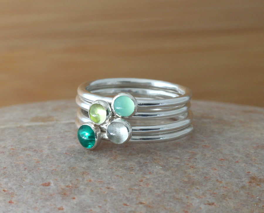 Green birthstone stacking rings in sustainable sterling silver. Emerald, peridot, chrysoprase, quartz. Handmade in New Jersey, US.