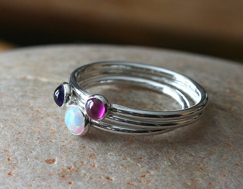 Small opal, ruby, and amethyst stacking rings handmade in New Jersey, US. with ethical silver.