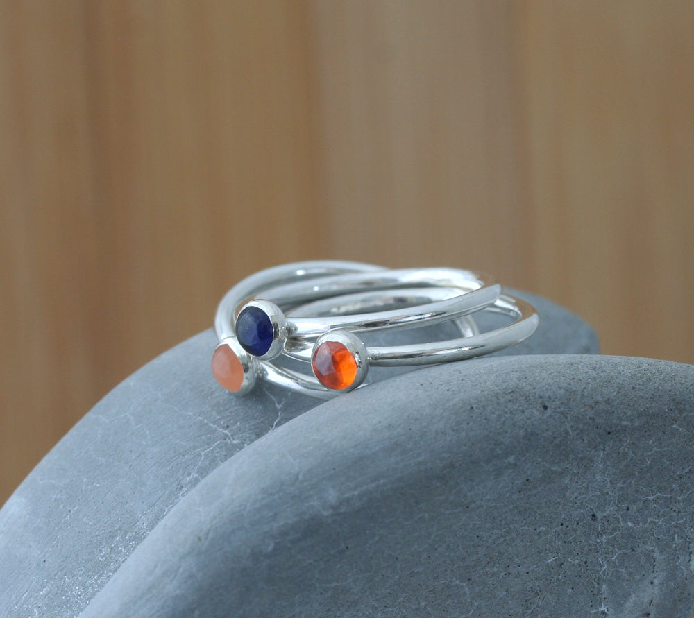 Orange cubic zirconia, peach moonstone and ethical blue sapphire stacking rings in all sizes. Ethical minimalist Scandinavian design. Handmade in New Jersey.