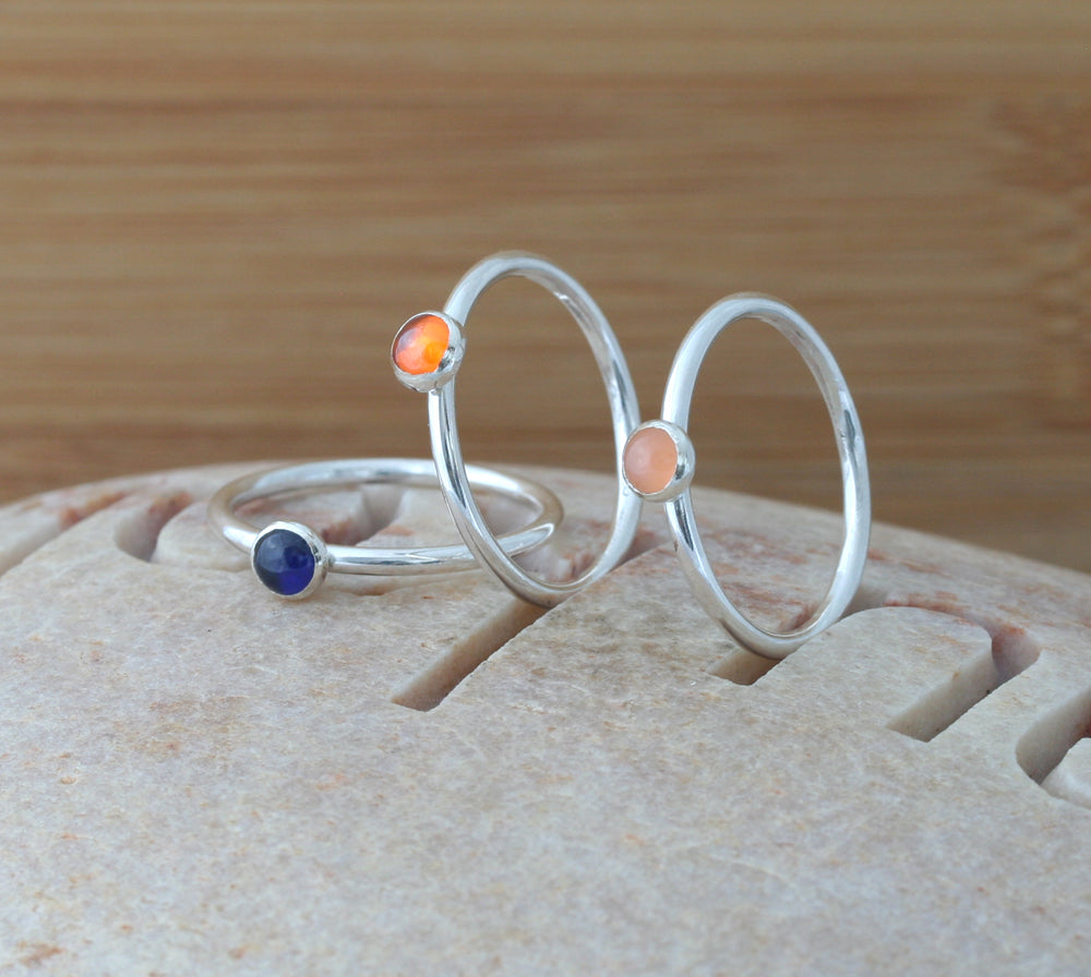 Orange cubic zirconia, peach moonstone and ethical blue sapphire stacking rings in all sizes. Ethical minimalist Scandinavian design. Handmade in New Jersey.