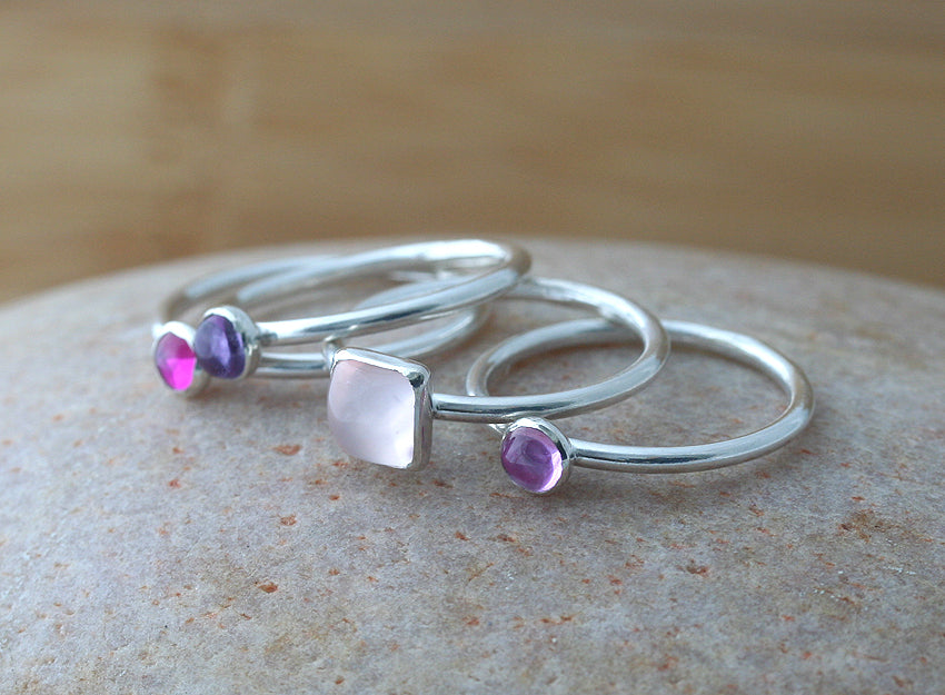 Pink and purple stacking rings in sustainable sterling silver. Handmade in the US.
