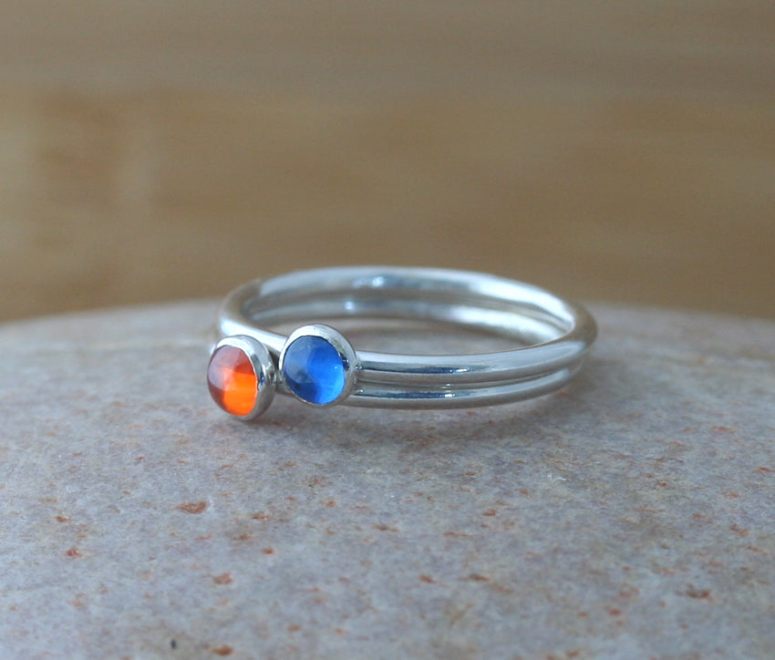 Orange cubic zirconia and blue spinel stacking rings in all sizes. Ethical minimalist Scandinavian design. Handmade in New Jersey.