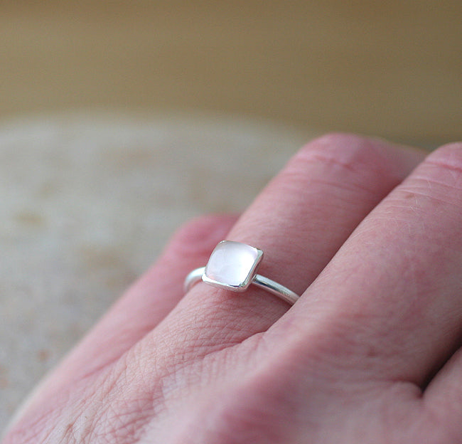 Rose quartz square stacking ring on finger. Sterling silver. Handmade in the US with sustainable silver.