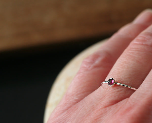Garnet stacking ring on finger. January birthstone. Ethical minimalist Scandinavian design. Handmade in New Jersey.