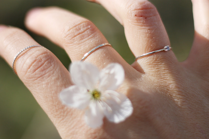 Thin twisted, hammered, and june birthstone stacking rings in sustainable sterling silver. Handmade in New Jersey, US.